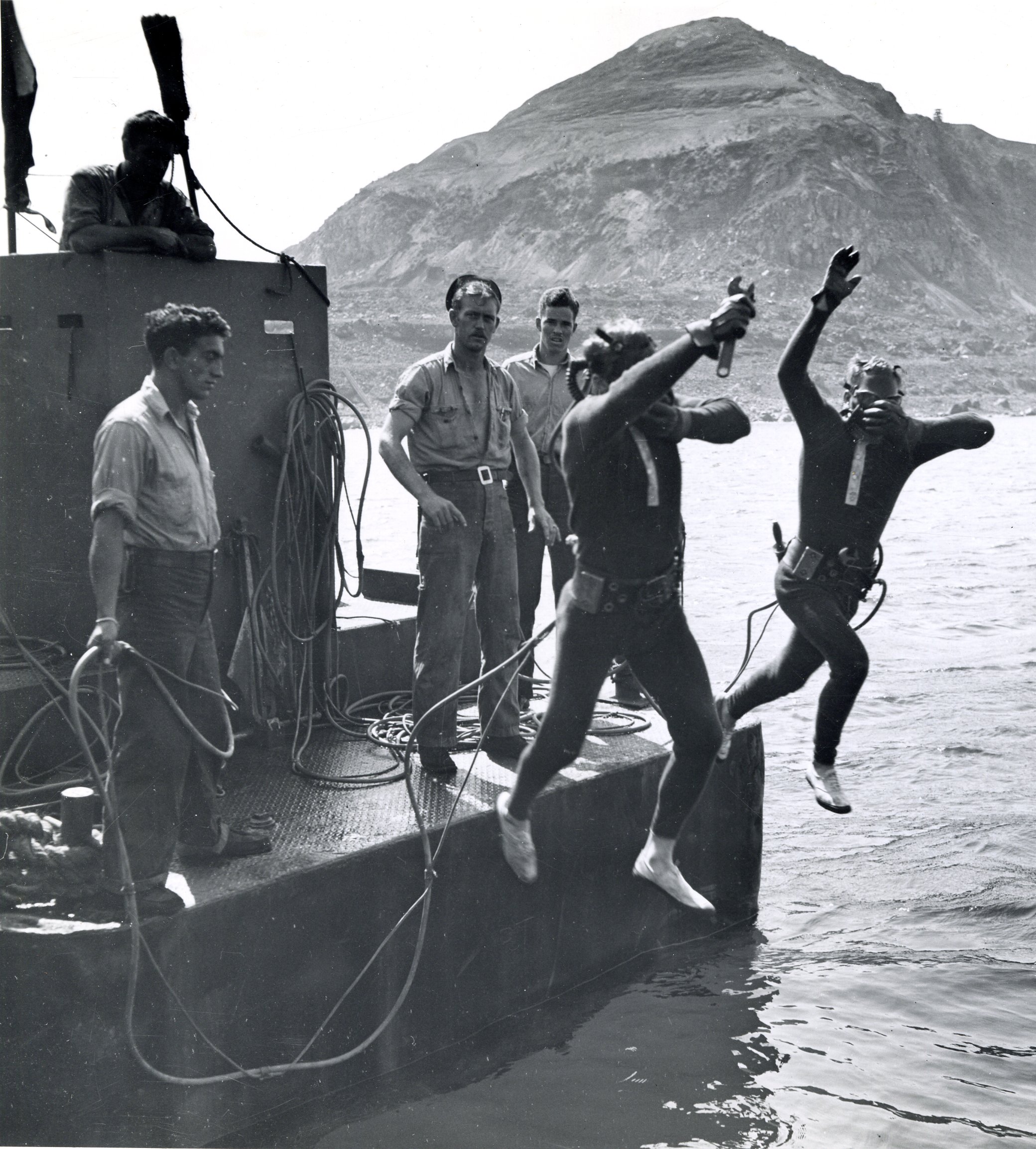 Surface supplied air divers jumping from a landing craft to do sub-surface salvage work. (U.S. Coast Guard) Surface supplied air divers jumping from a landing craft to do sub-surface salvage work. (U.S. Coast Guard)